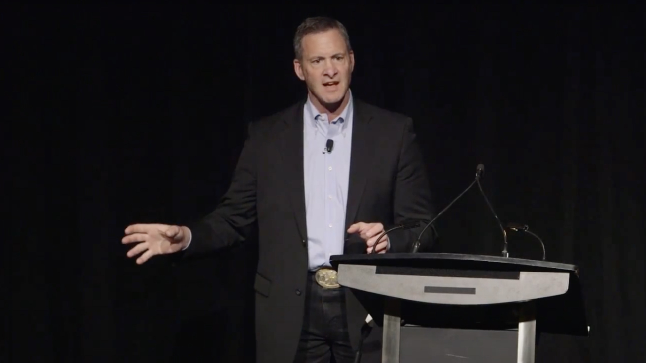 Clint Malarchuk speaking at podium